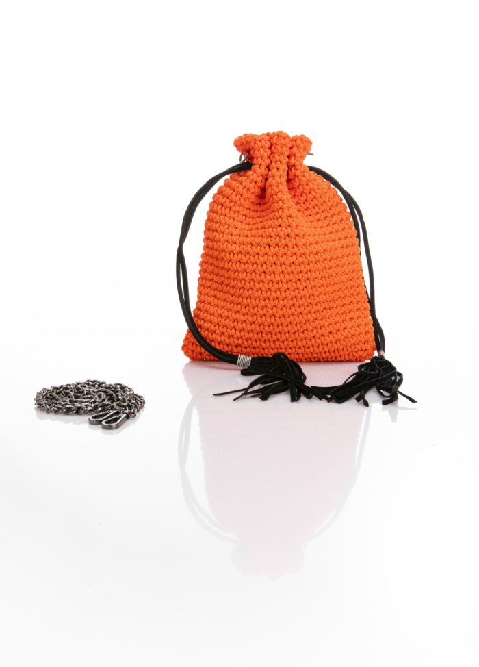 a mini handmade crochet pouch bag in orange